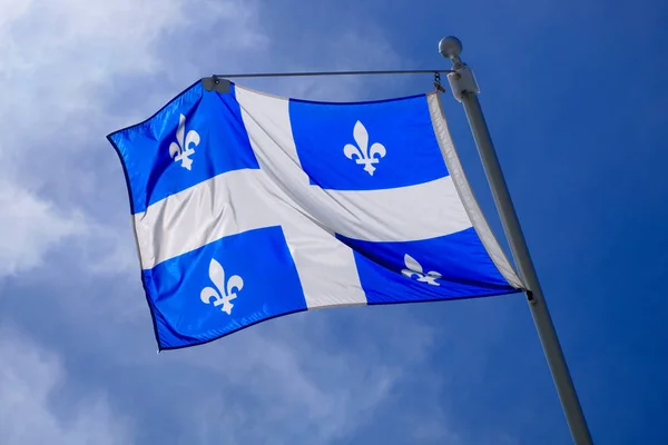 Quebec Flag pole on blue sky national st-jean banner