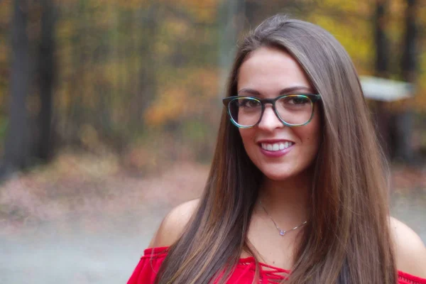 Chica sonriendo pelos marrones usando gafas fuera de otoño —  Fotos de Stock