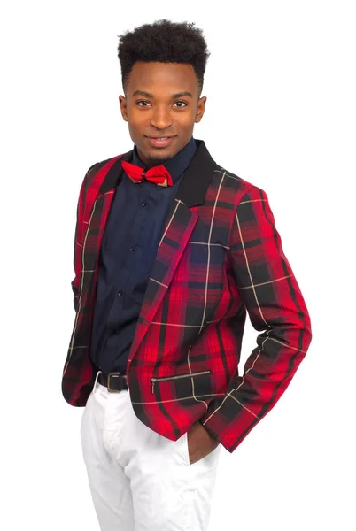 Afrikai fiatalember körül húsz stúdió fehér háttér piros kockás ruha kabát és a csokornyakkendő fehér nadrágot viselt — Stock Fotó