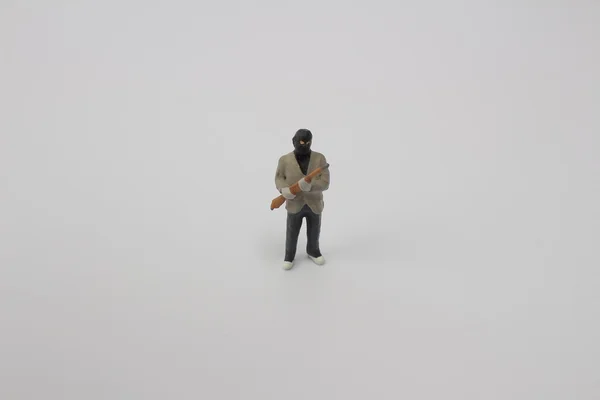 Thief man miniature figure with gun — Stock Photo, Image