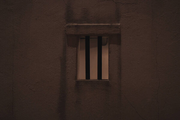 big brick wall of the old building with the damaged plaster 