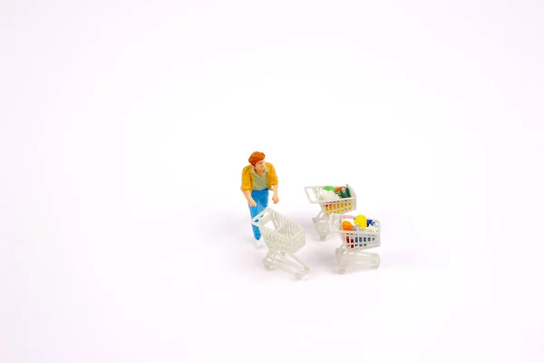 Clientes em miniatura com carrinhos de compras — Fotografia de Stock