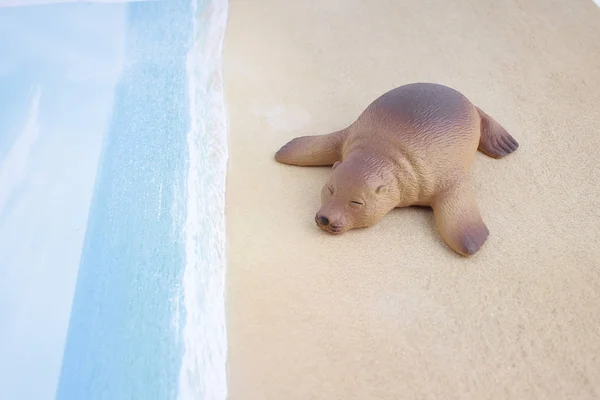 Plastic sea lion toy with figure — Stock Photo, Image