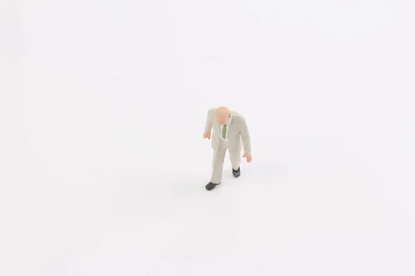 Miniaturmenschen auf weißem Hintergrund — Stockfoto