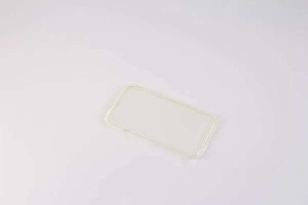 Caixa de plástico para telefone inteligente no fundo branco — Fotografia de Stock