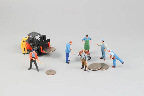The workers with coin money at site — Stock Photo, Image