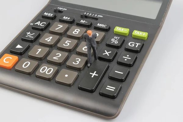 The toy business man on calculator isolated — Stock Photo, Image