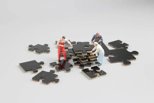 Mini minuscules constructeurs sur le chantier de construction de puzzle — Photo