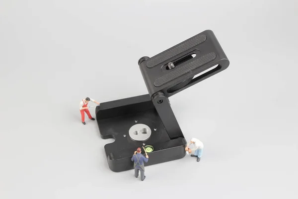 Group of construction workers repairing tool — Stock Photo, Image