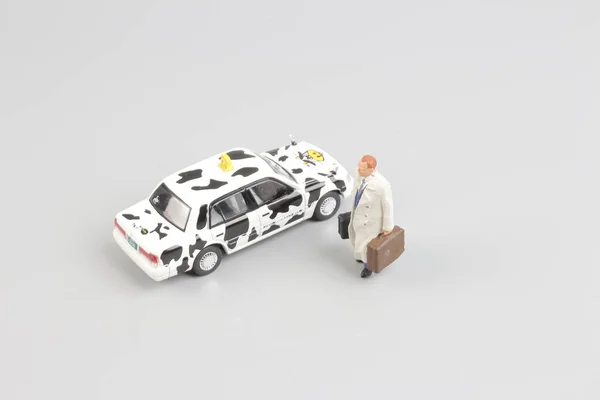 Tiny of toy taxi with the traveler figure — Stock Photo, Image