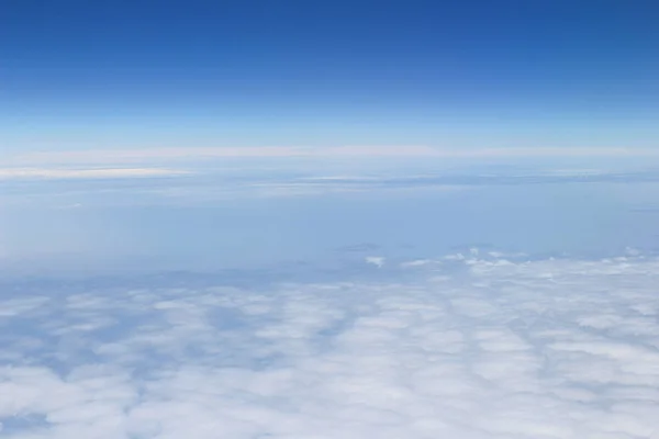 Blue sky high view from airplane clouds shapes — Stock Photo, Image