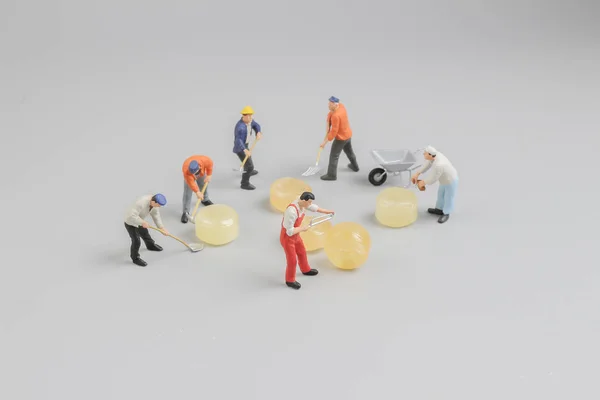 Mini of painters of workers with candy — Stock Photo, Image