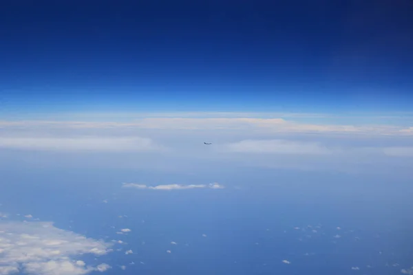 View of clouds from the window of a jet aircraft.