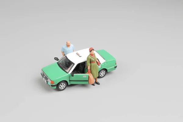 Small figure with green taxi at hk — Stock Photo, Image