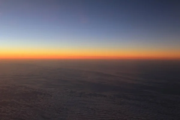 Amazing view from plane on the sky, sunset sun and clouds — Stock Photo, Image