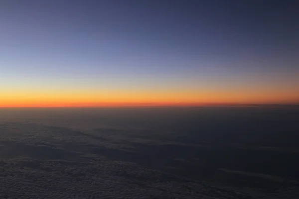 Amazing view from plane on the sky, sunset sun and clouds — Stock Photo, Image