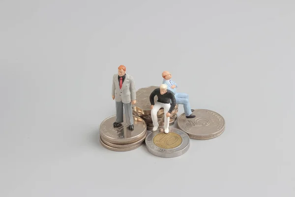 Business figure  on the top of coins stack