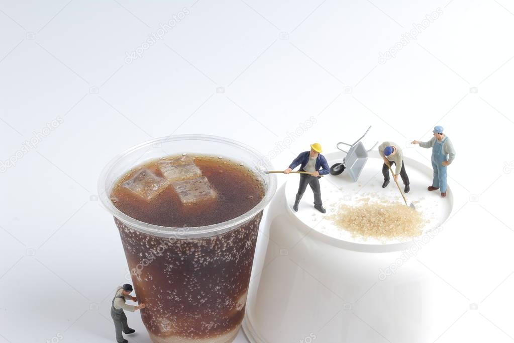 Mini people workers with cup of soft drink