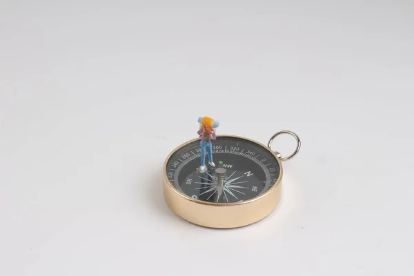 Fun of Min figure standing on compass — Stock Photo, Image