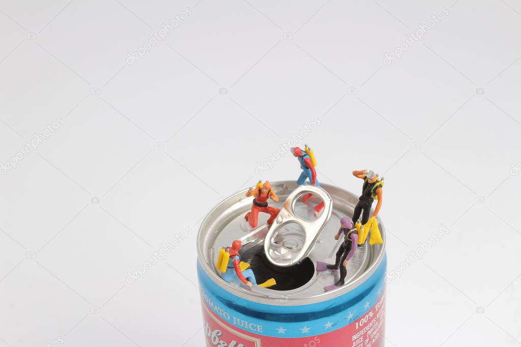 small  diver stands on an open aluminum can