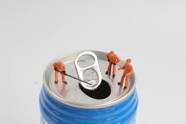min worker on top of soda can  clipart