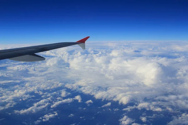 Cloud sky view from air plane window next to a wing — Stock Photo, Image