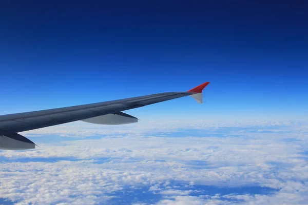 Cloud sky view from air plane window next to a wing — Stock Photo, Image