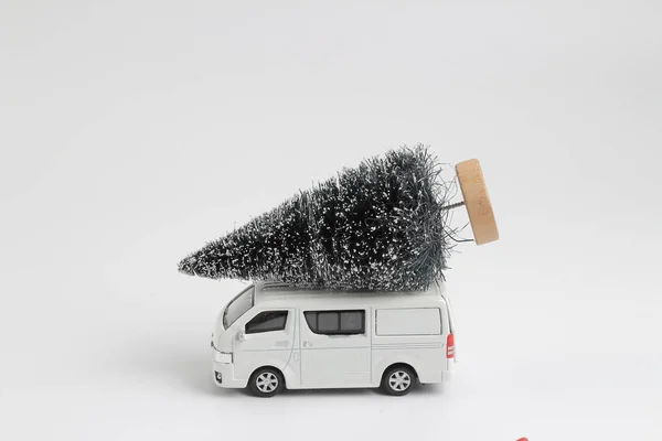 Transport van with christmas tree on white — Stock Photo, Image