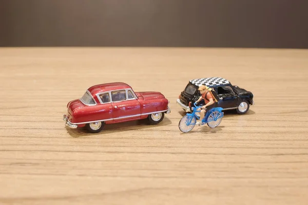 The small figure and toy car and bike — Stock Photo, Image