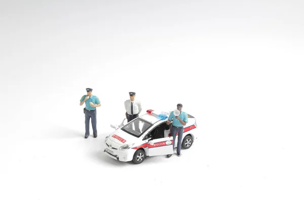 Police officer stands in with of police car — Stock Photo, Image