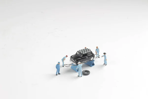 Mini mécanique des figurines travaillant sur une voiture — Photo