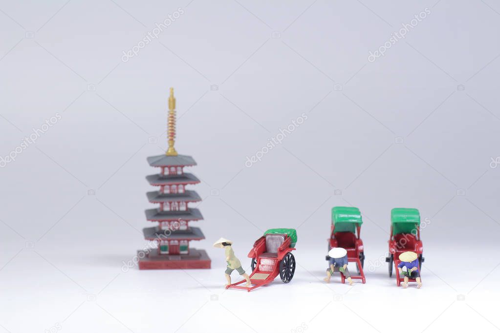 Mini statue and red vintage oriental rickshaw cab