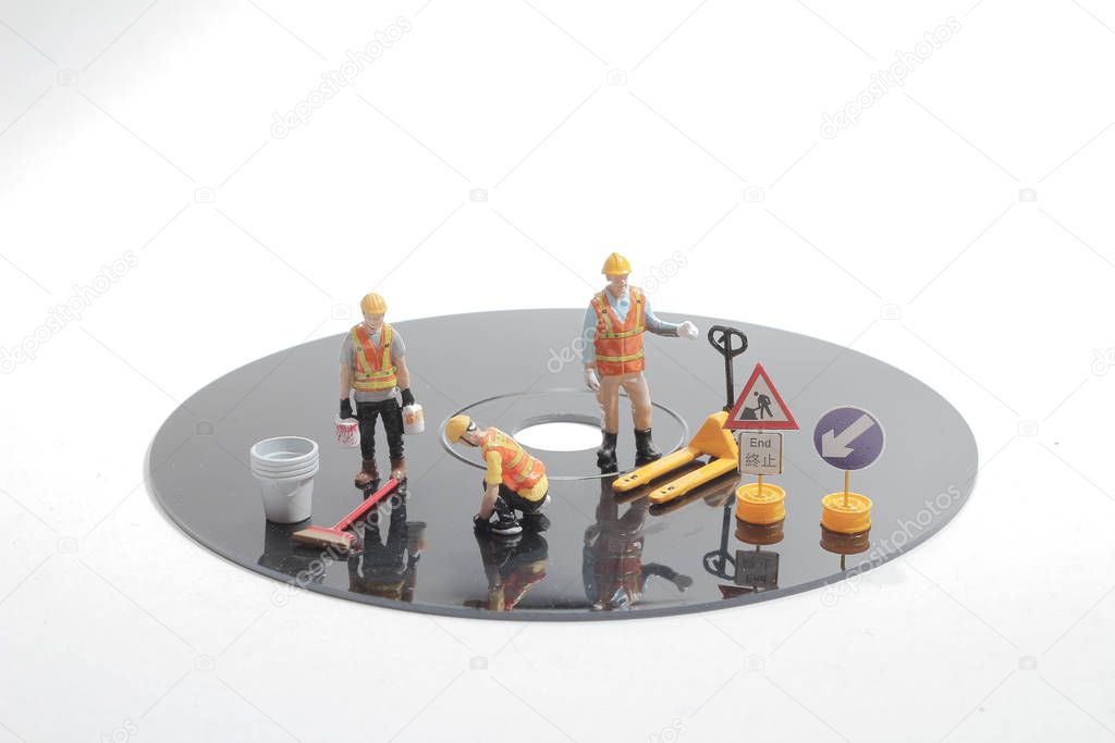 Mini people worker holding tool on white background,