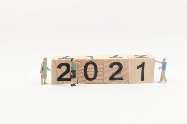 Worker team build wooden number 2021 Mini people