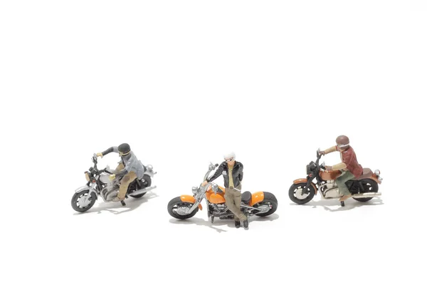 a group of figure ride the motorcycle
