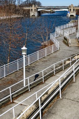 Manistee; 's River Walk with a Draw Bridge in the Background