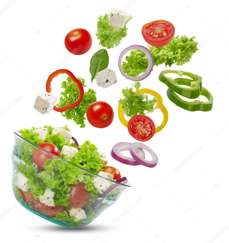 Falling vegetables in a salad bowl