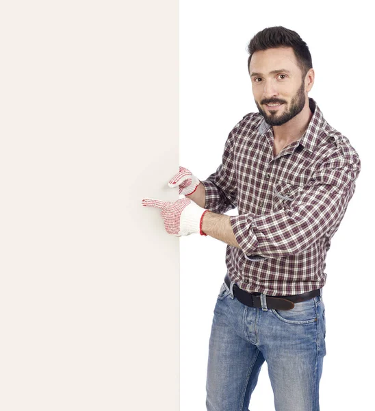 Handyman pointing at blank board — Stock Photo, Image