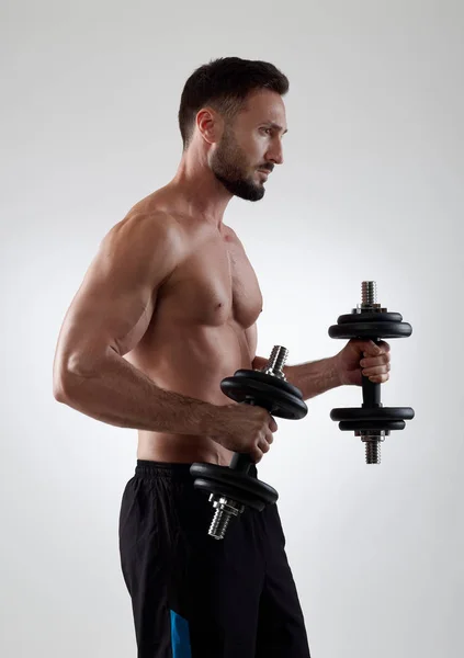 Sportsman with dumbbells — Stock Photo, Image