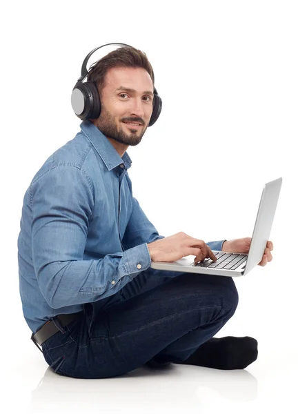 Homem com laptop e fones de ouvido — Fotografia de Stock