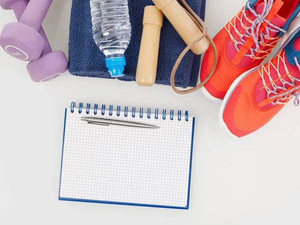 Notebook and sport equipment — Stock Photo, Image