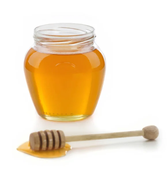 Honey jar and dipper Royalty Free Stock Images