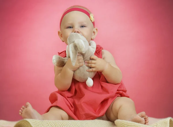 Happy little girl with toy — Stock Photo, Image