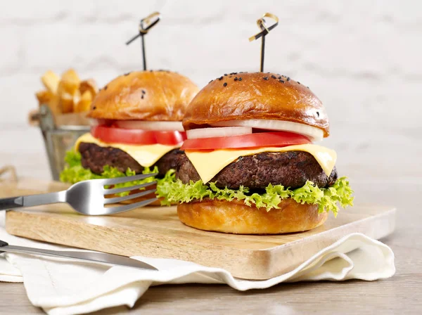 Burgers on cutting board — Stock Photo, Image