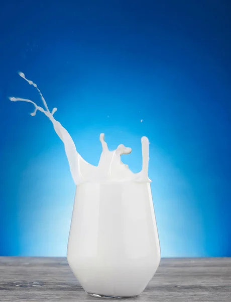 Milk splash in a glass — Stock Photo, Image