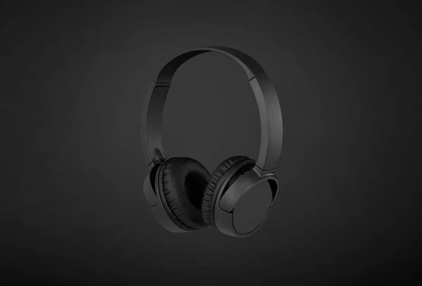 Black headphones on black background — Stock Photo, Image