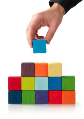 El, tahta küpü piramidin tepesine koyuyor