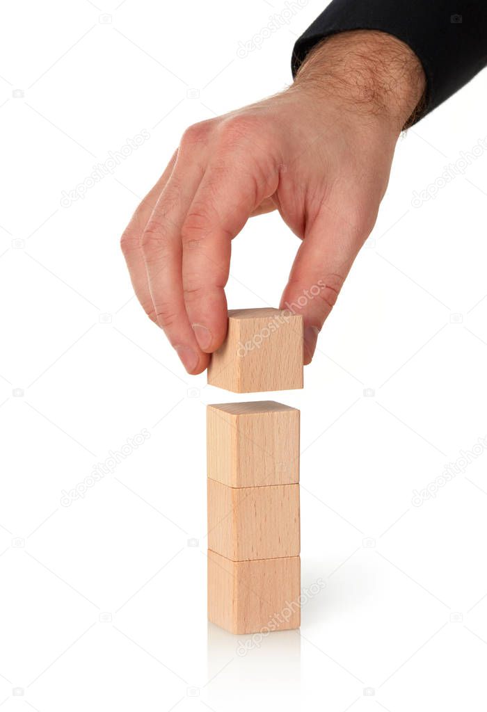 Businessman stacking wood blocks