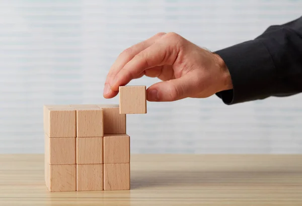 Hand Arranging Wooden Block Desk — Stock Photo, Image