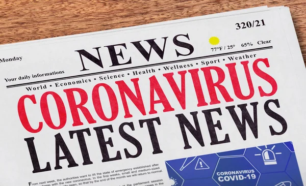 Coronavirus latest news headline on newspaper